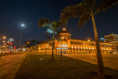 Illuminated building against sky at night