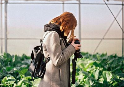 Woman standing by plants