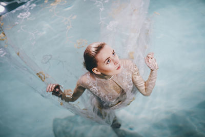 High angle view of woman swimming in pool