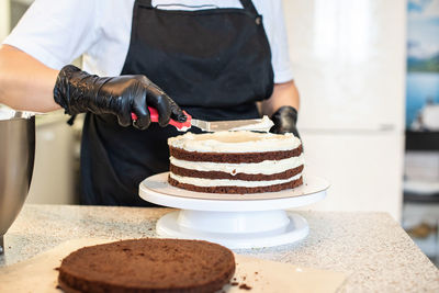 Midsection of man holding cake