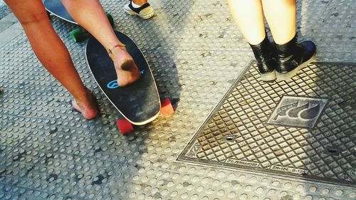 Low section of woman standing on tiled floor