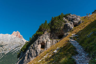 Low angle view of rock formation against clear blue sky