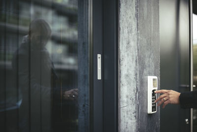 Cropped image of businessman's hand entering security code to open office door