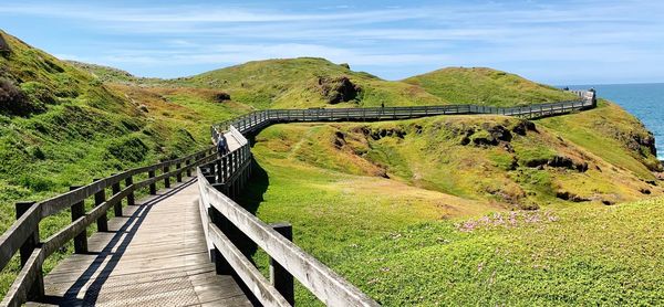 Scenic view of bridge over mountains against sky