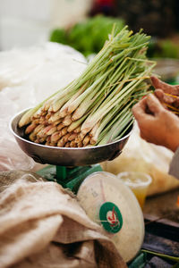 Close-up of scallions on weight scale in market for sale