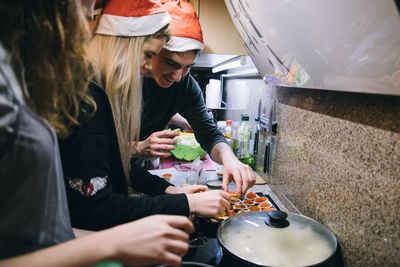 Friends preparing food at home