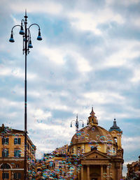 Low angle view of street and buildings against sky