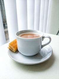 Close-up of coffee cup on table