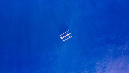 High angle view of airplane flying over sea