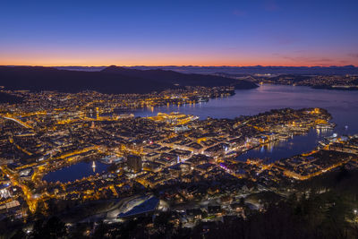 High angle view of illuminated city buildings at night