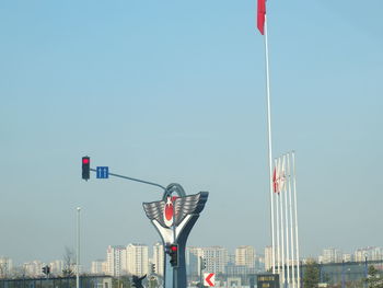 Flag by city against clear sky