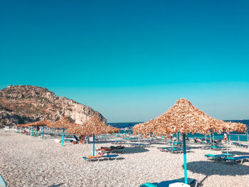 Built structure on beach against clear blue sky