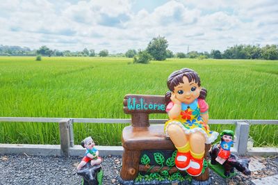 Portrait of a boy with toy on field