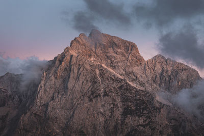 Background photo of low clouds in a mountain valley, vibrant blue and orange pink sky