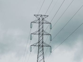 Low angle view of electricity pylon against sky