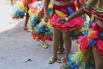 Low section of people walking on street