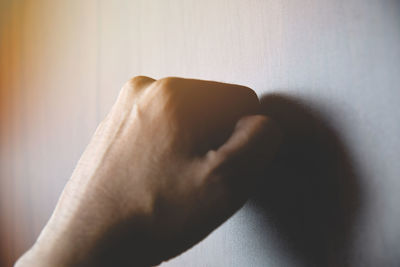 Close-up of person hand on bed at home