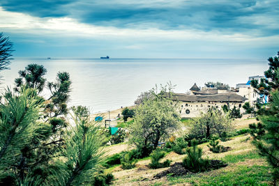 High angle view of sea and buildings against sky