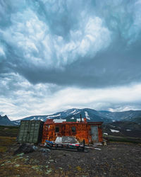 Buildings on field against sky