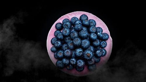 Close-up of blueberries against black background