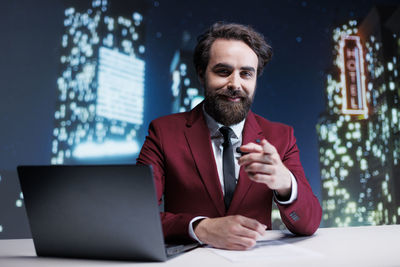 Portrait of young man using laptop at home