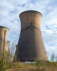 Low angle view of factory against sky