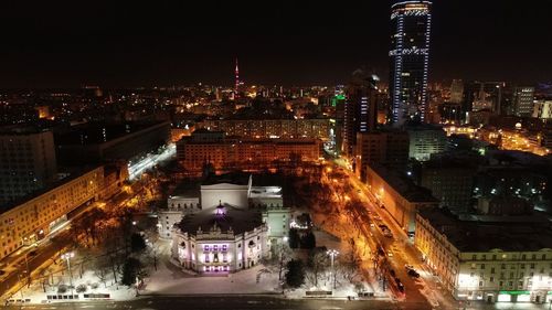 High angle view of city lit up at night