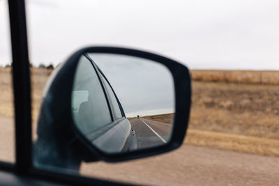 Reflection of car on side-view mirror