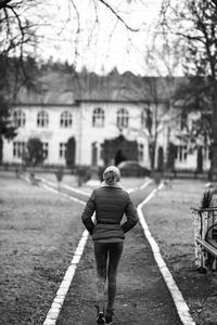 Rear view of man walking on road