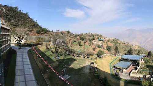 High angle view of road by trees against sky