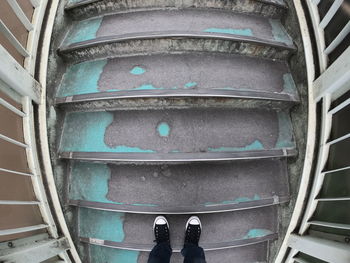 Low section of person standing on staircase