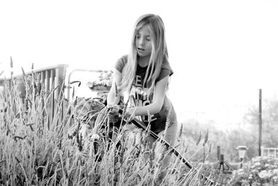 Girl watering plants in garden