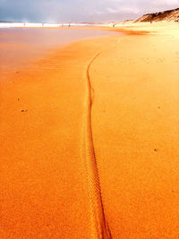 Scenic view of beach against sky during sunset