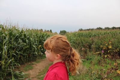 Girl standing on grassy field