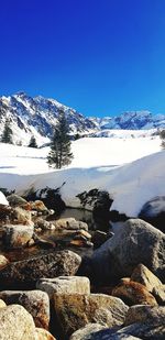 Scenic view of snowcapped mountains against clear blue sky