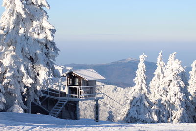 Scenic view of snow covered mountains against clear blue sky