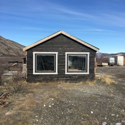 Exterior of house on field against sky