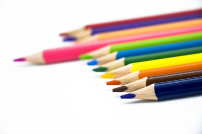 Close-up of colored pencils against white background