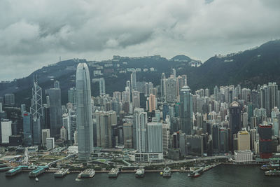 Aerial view of buildings in city against sky