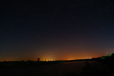 Scenic view of silhouette landscape against star field at night