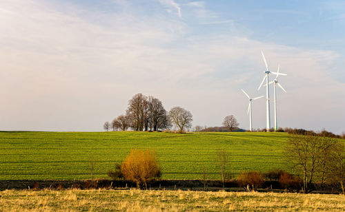 Windmill on field against sky