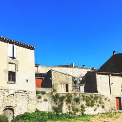 Low angle view of house against clear blue sky