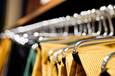 Close-up of textiles hanging on coathangers