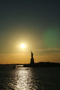 Silhouette of statue at sunset