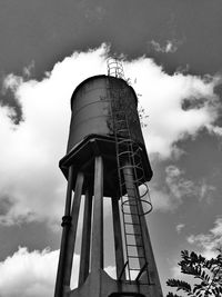 Low angle view of tower against cloudy sky