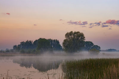 Scenic view of lake against sky during sunset