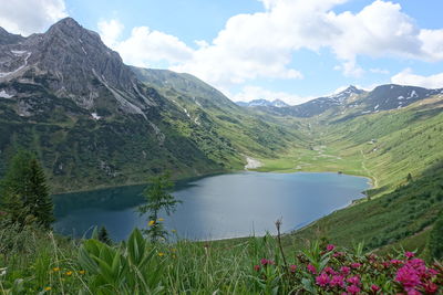 Scenic view of lake and mountains against sky