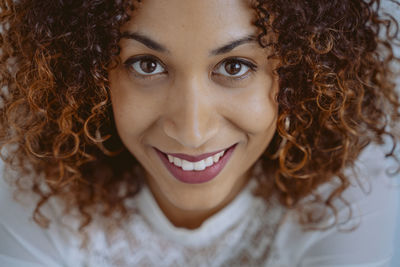 Close-up portrait of smiling young woman