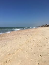 Scenic view of beach against clear sky