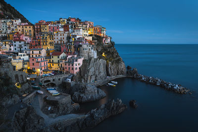 Panoramic view of sea and buildings against sky